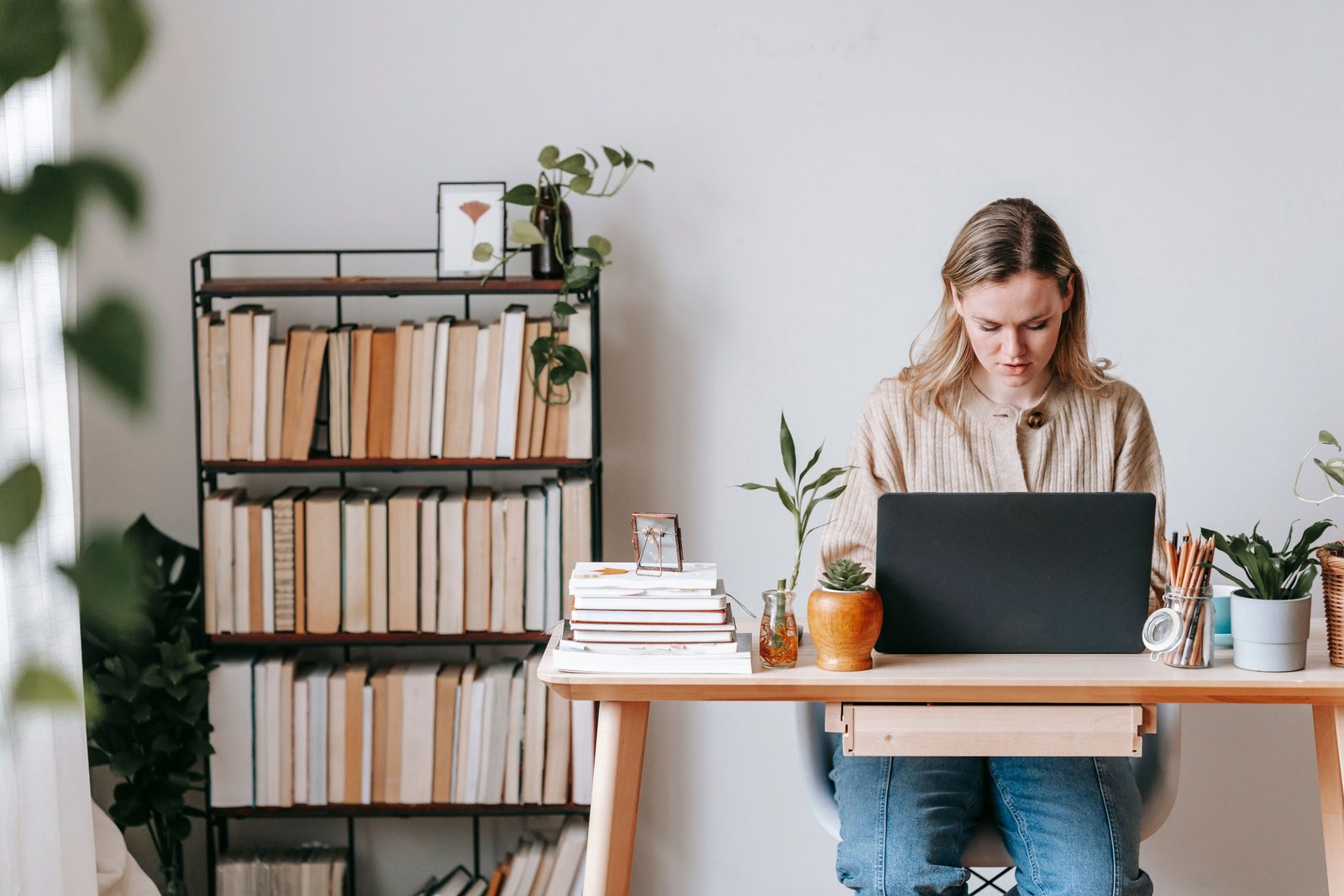 Person working on a laptop at a modern home desk — best AI tools for real estate agents